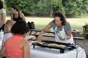 Chef and teacher, Deanna Cook, heats local corn tortillas for kids to make quesadillas.