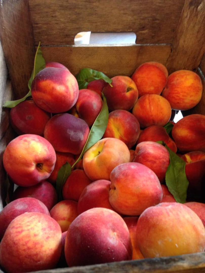 Loose peaches in a crate